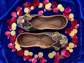 Blue and gold peacock pom-pom jutti - top-down flat-lay view
